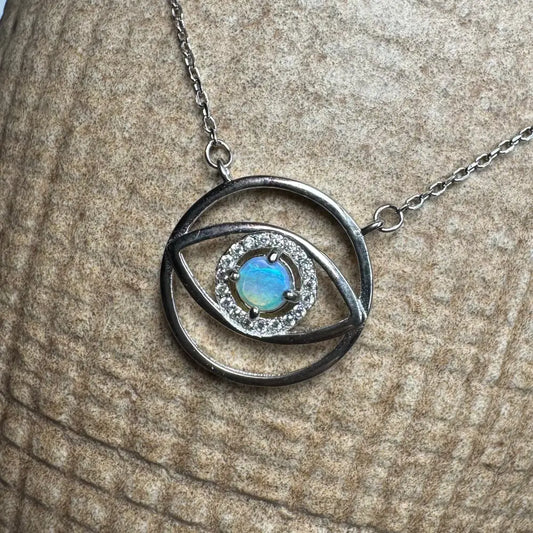 Silver eye pendant necklace with a luminous opal center from Lightning Ridge