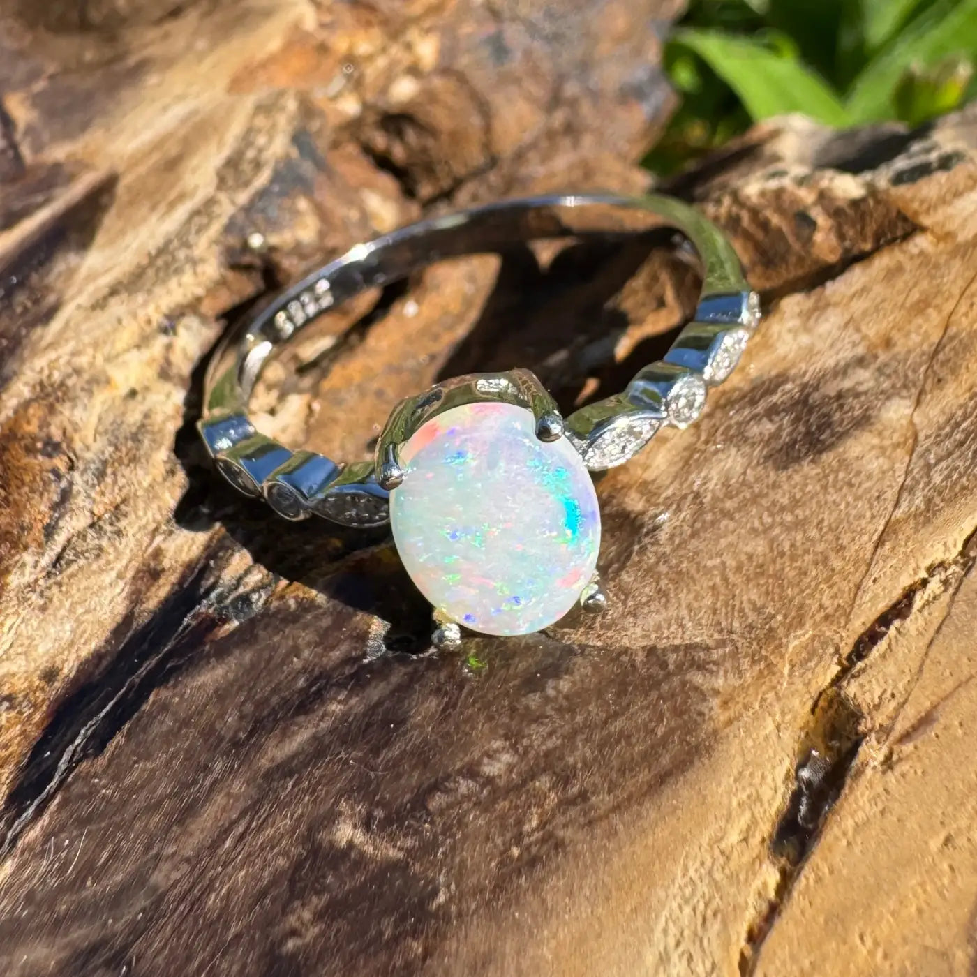 Silver ring featuring iridescent Coober Pedy crystal opal in handcrafted design
