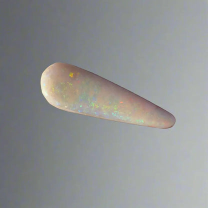 Elongated Coober Pedy opal gemstone with iridescent flashes in a 2.6carat solid hand-cut form