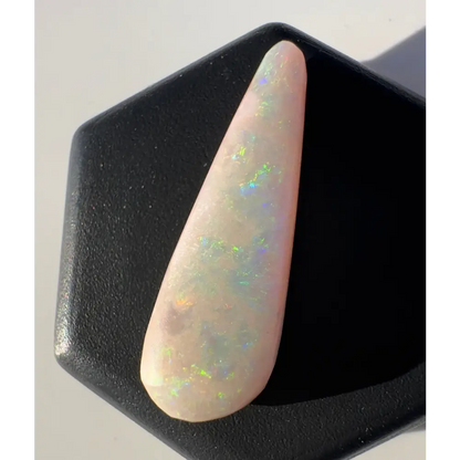 Iridescent white opal gemstone from Coober Pedy weighing 2.6 carats and hand-cut