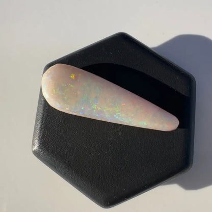 Iridescent elongated opal gemstone from Coober Pedy weighing 2.6 carats