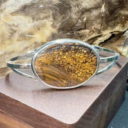 Silver bracelet with brown and yellow stone.