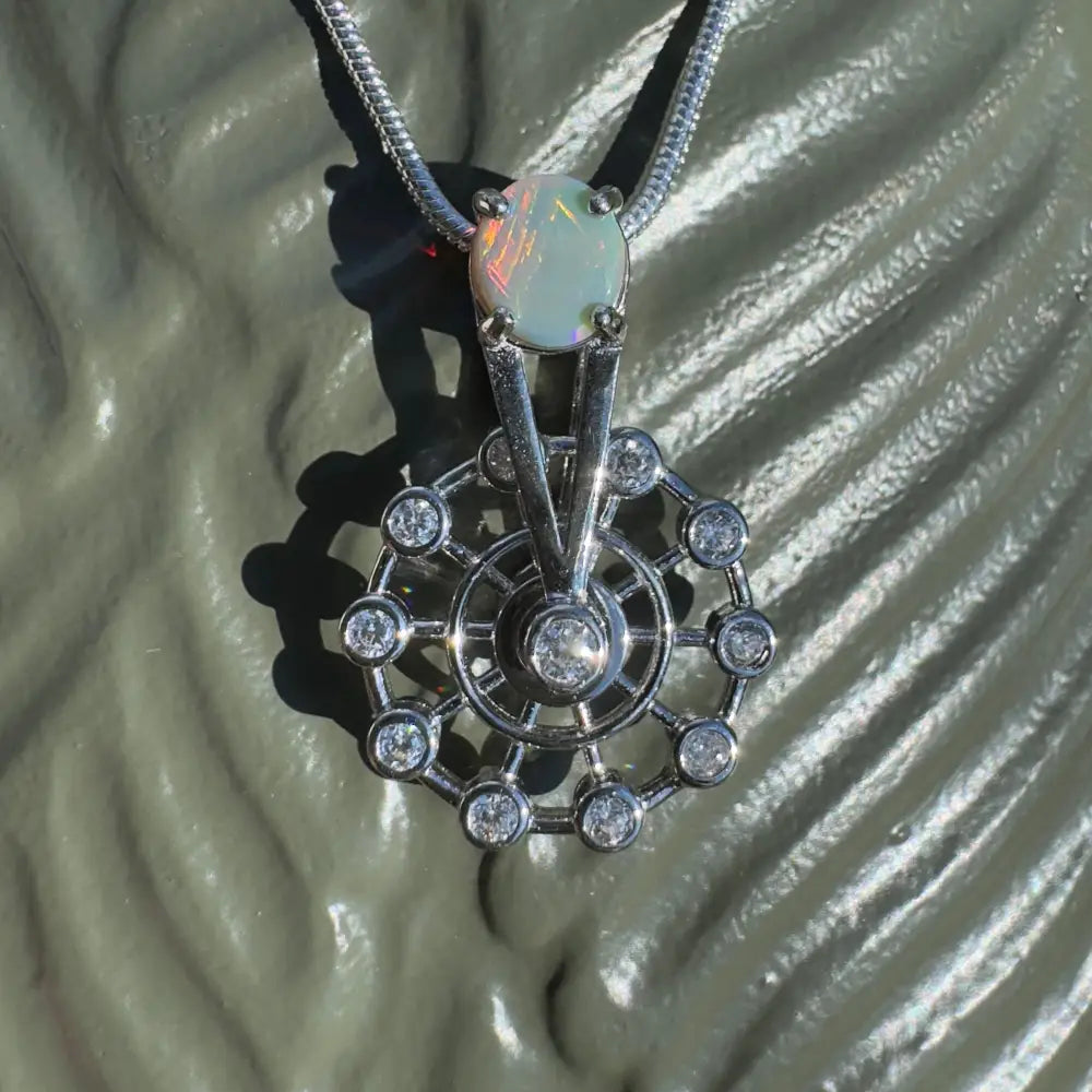 Opal and diamond pendant necklace featuring a handcrafted Lightning Ridge Opal and sterling silver ferris wheel design