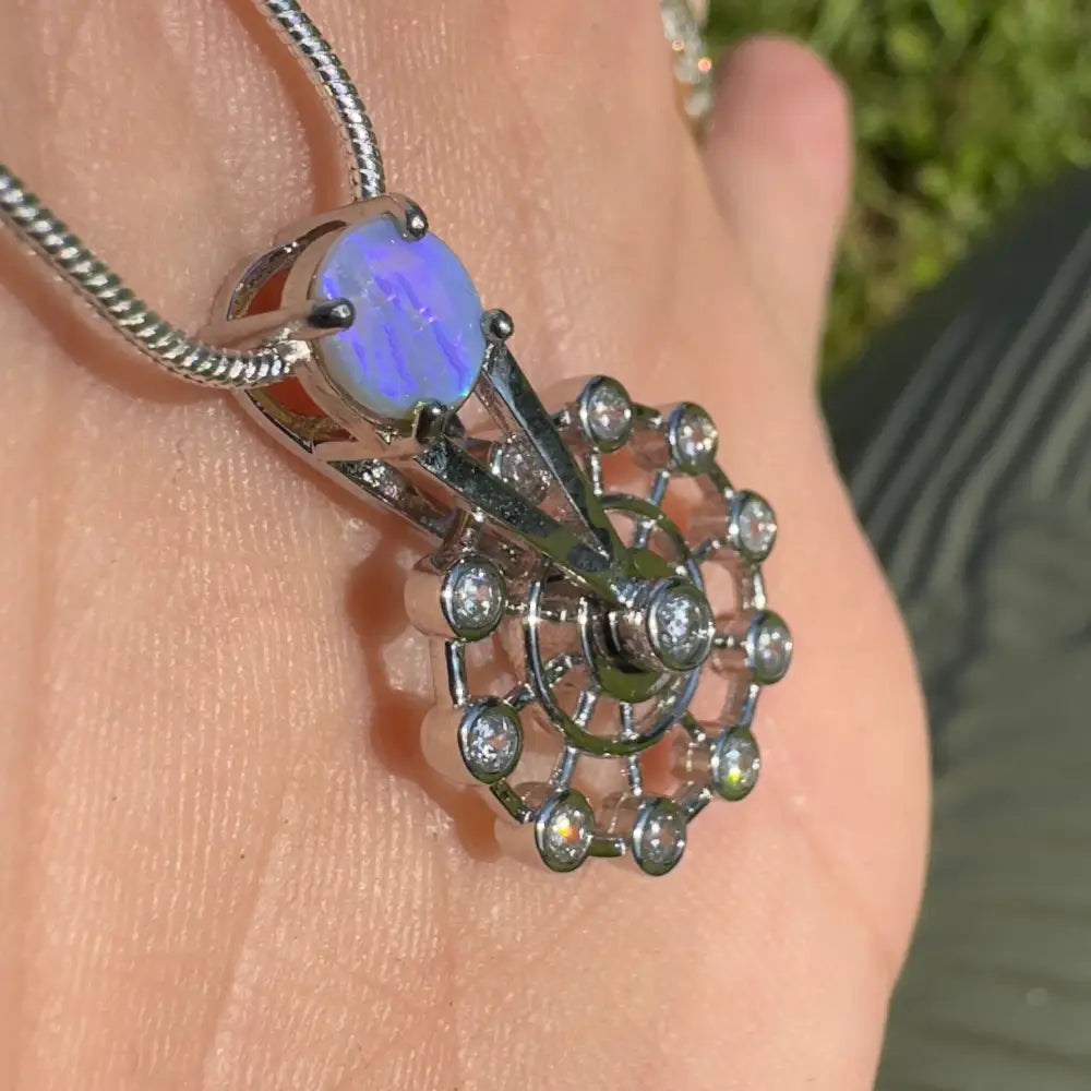 Silver pendant featuring a Lightning Ridge opal and diamond accents in sterling silver