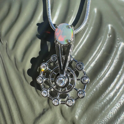 Silver spinning ferris wheel pendant with Lightning Ridge opal and diamond accents