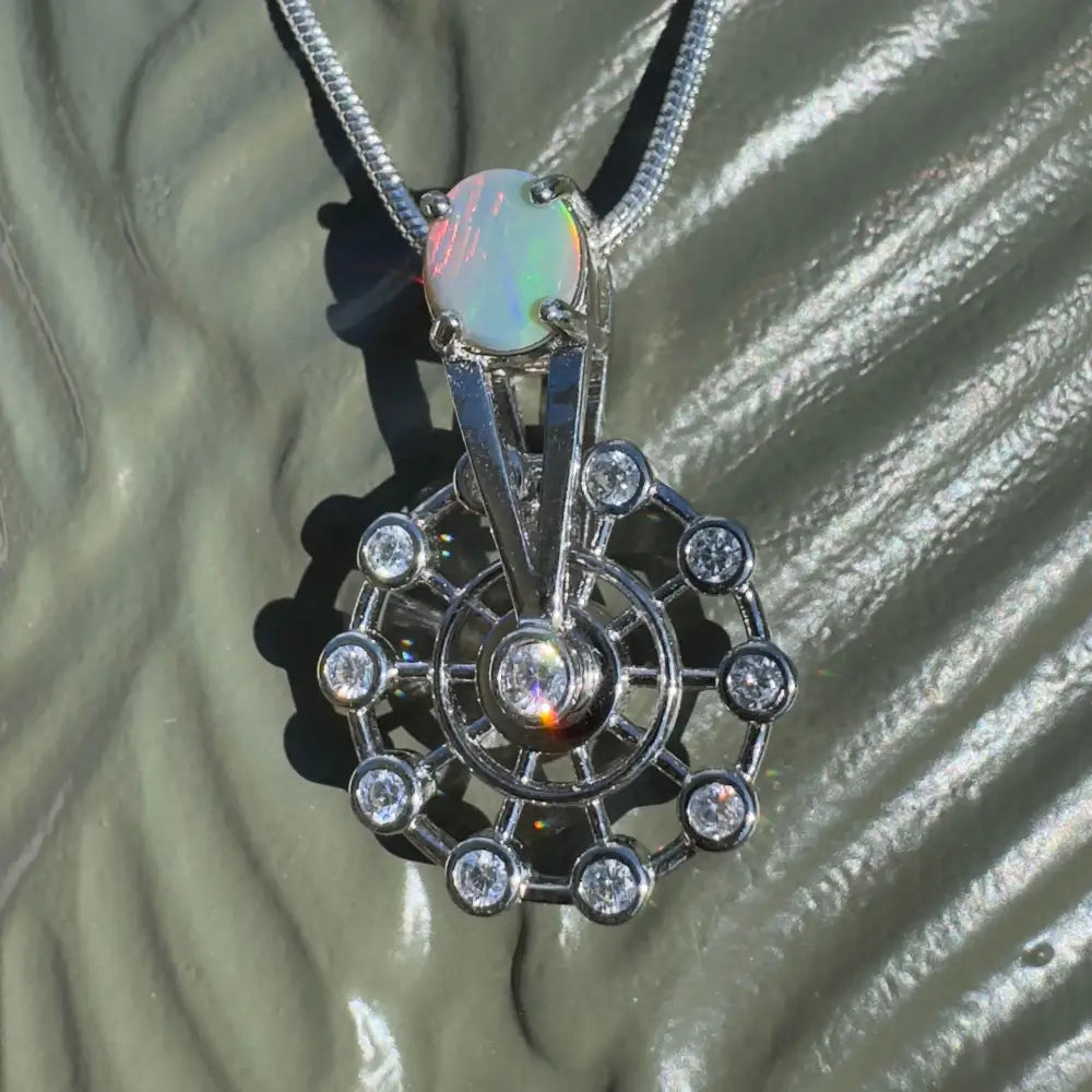 Silver spinning ferris wheel pendant with lightning ridge opal and diamond accents
