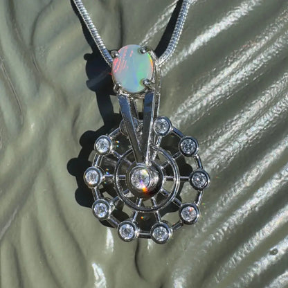 Silver spinning ferris wheel pendant with lightning ridge opal and diamond accents