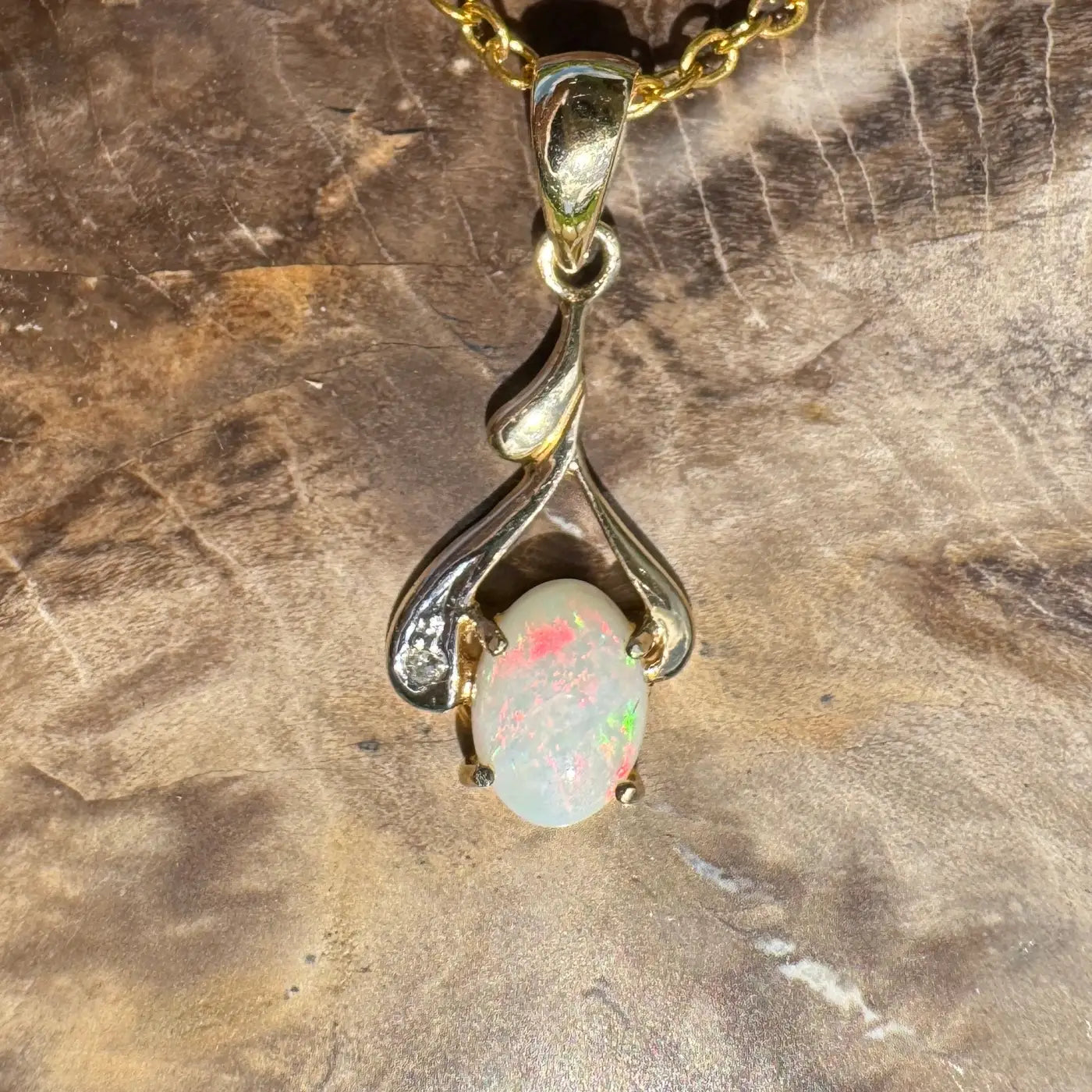 Gold and silver opal pendant necklace featuring a handcrafted Coober Pedy opal and natural diamonds