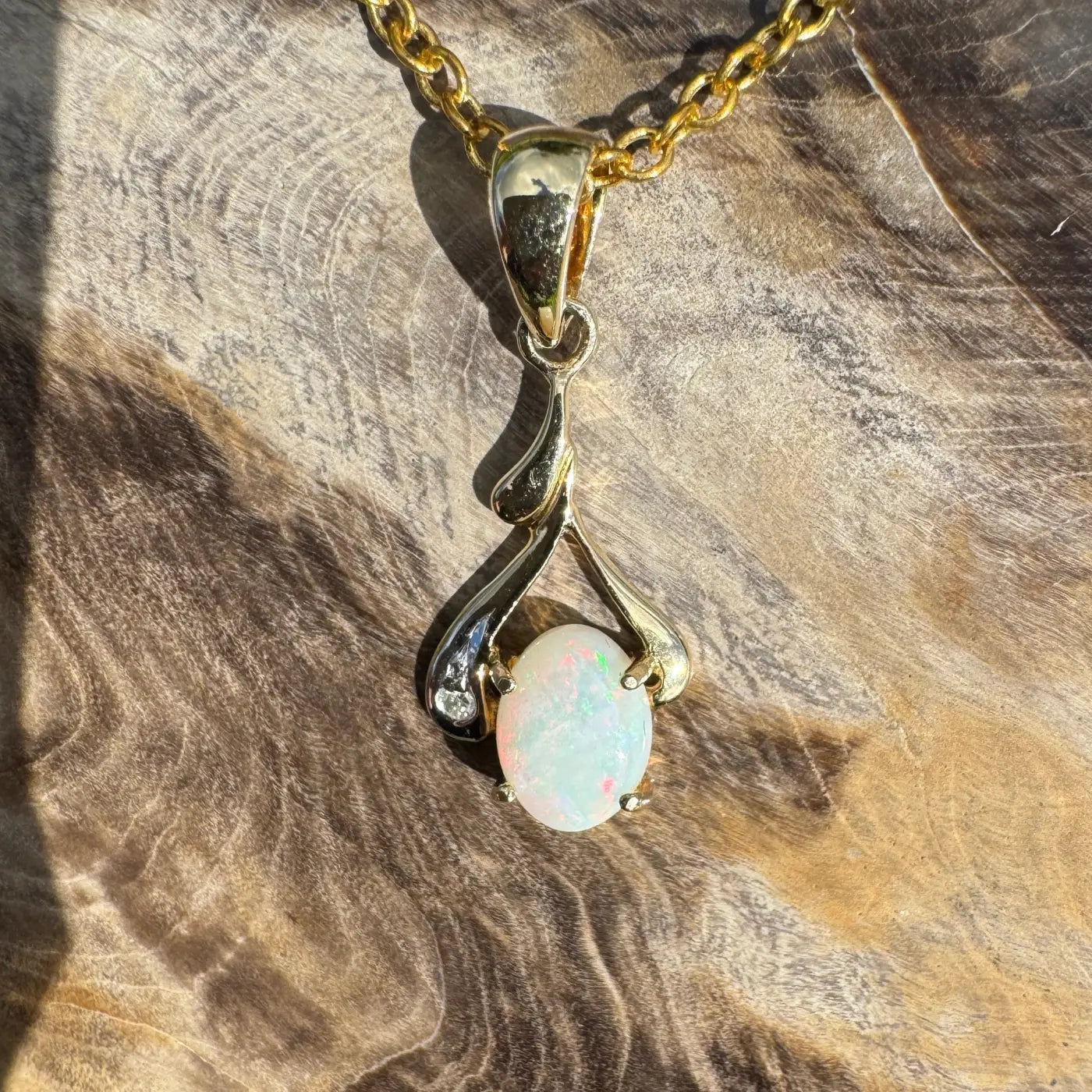 Gold opal pendant necklace featuring a handcrafted 0.7ct Coober Pedy opal with natural diamonds