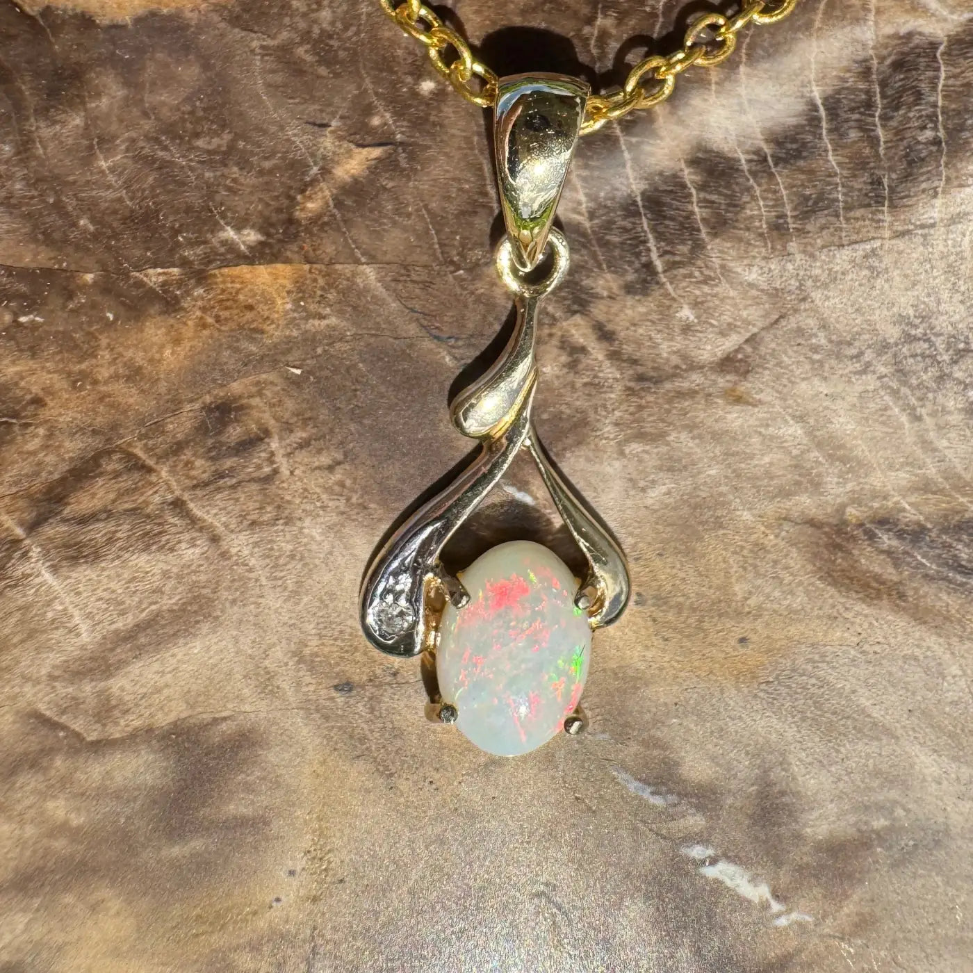 Gold chain necklace with a 0.7ct Coober Pedy opal pendant and natural diamonds