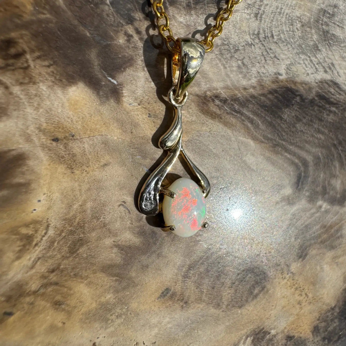 Gold and silver opal pendant necklace featuring a handcrafted 0.7ct Coober Pedy opal with diamonds