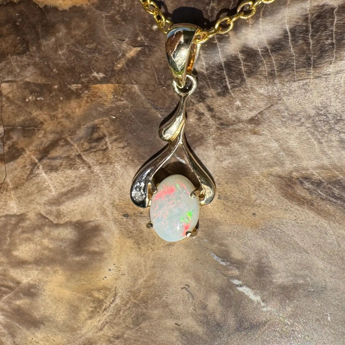 Gold opal pendant necklace featuring a handcrafted 0.7ct Coober Pedy opal with natural diamonds