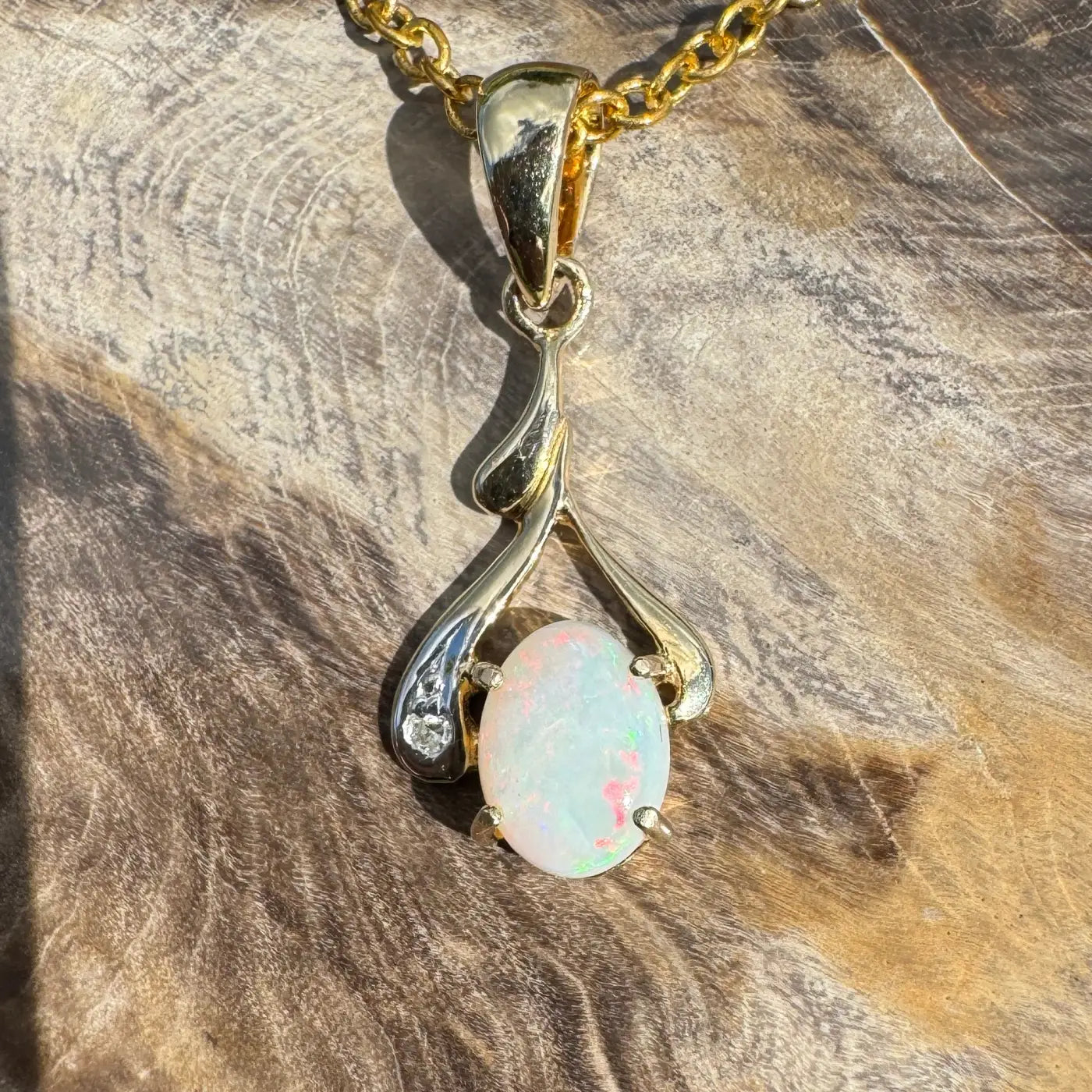 Gold and silver opal pendant necklace featuring a 0.7ct Coober Pedy opal and natural diamonds