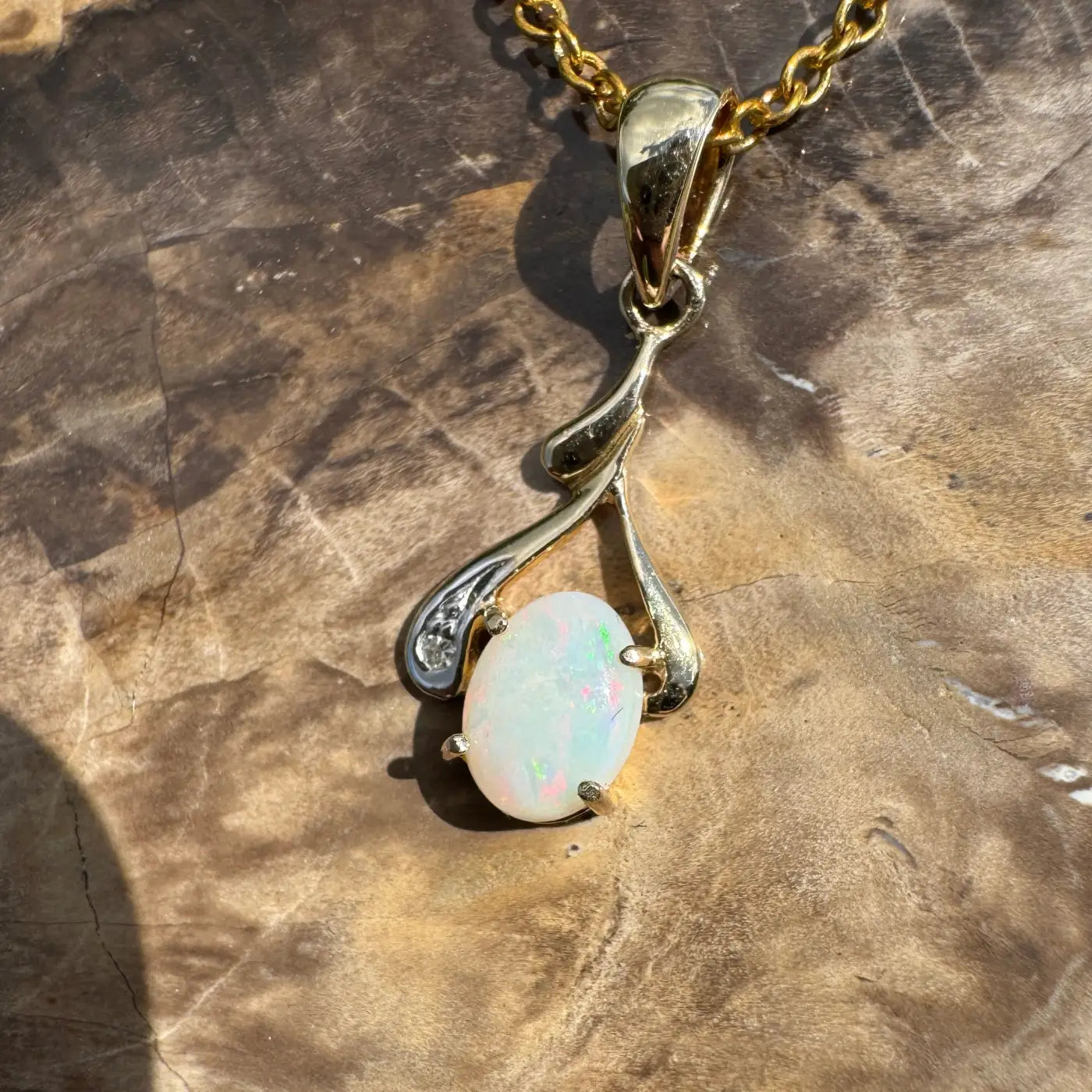 Gold pendant necklace featuring a 0.7ct Coober Pedy Opal and natural diamond