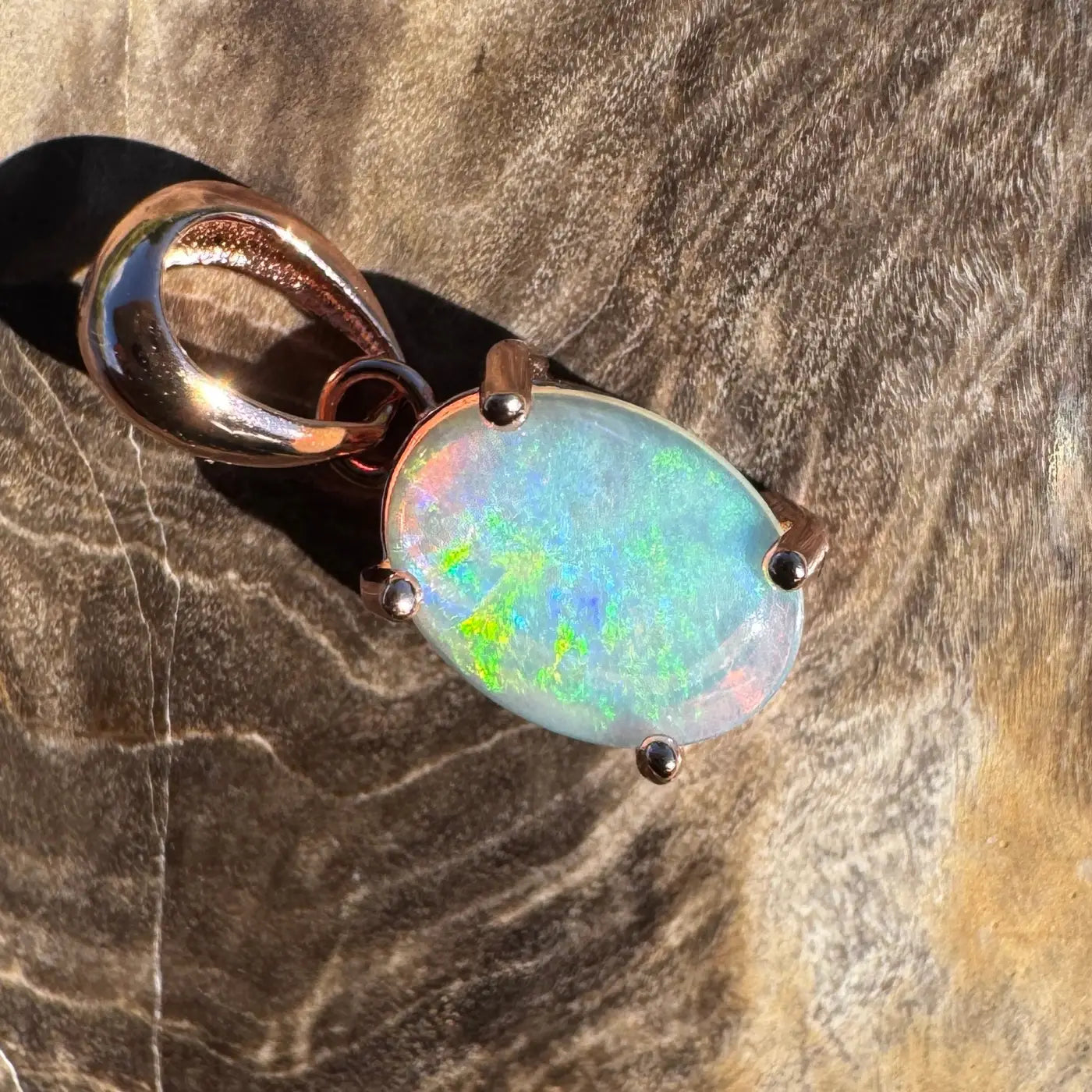 Oval Lightning Ridge Opal pendant with rose gold setting in handcrafted jewelry design