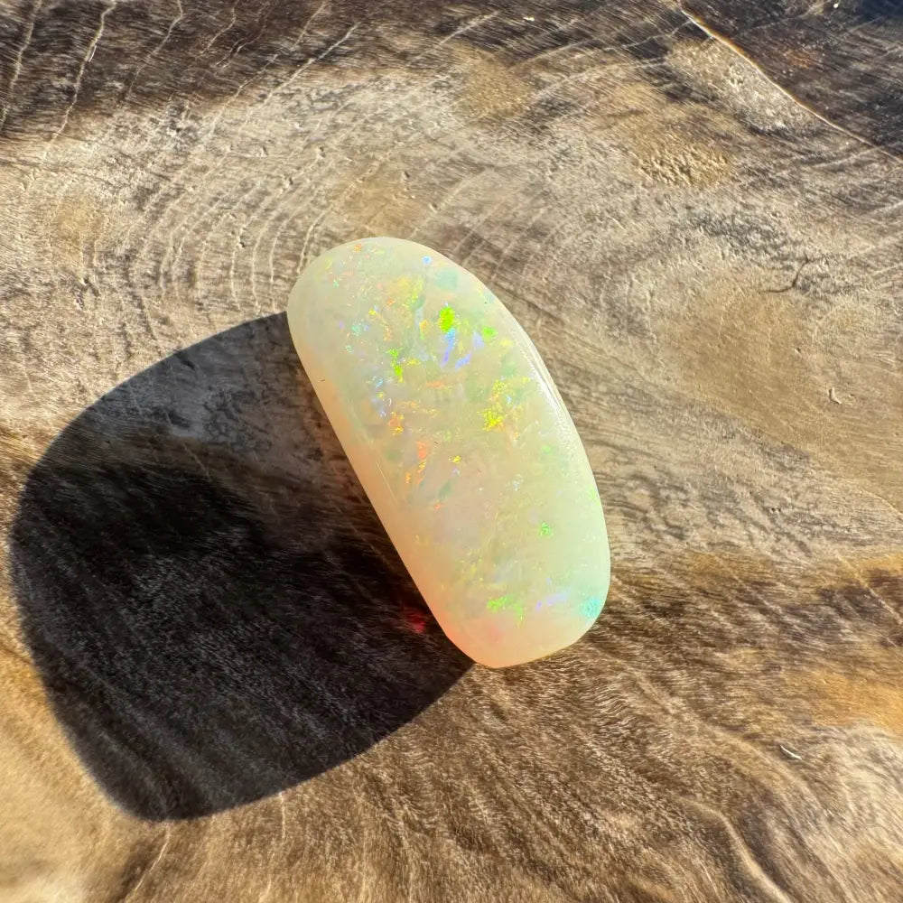 Iridescent white opal cabochon displayed in Hand-Cut Solid Coober Pedy Opal 2.9carat