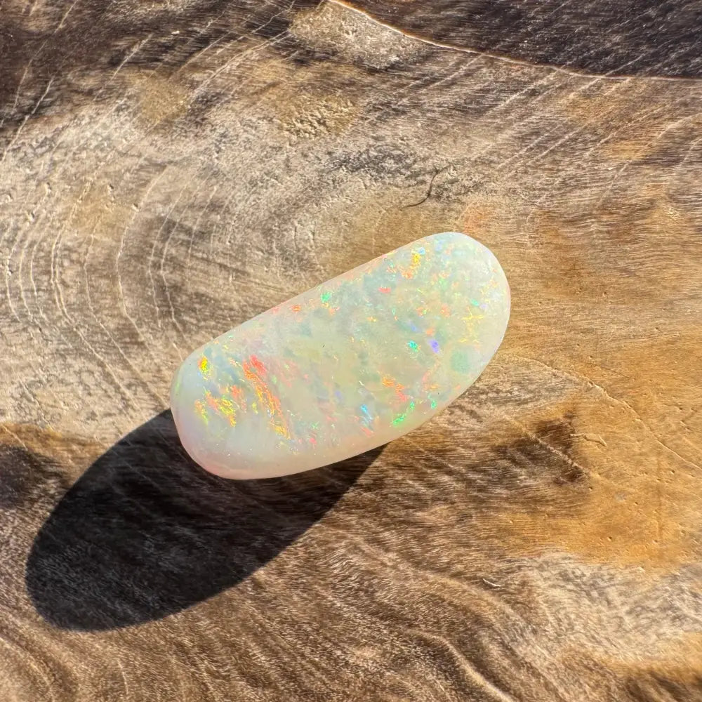Iridescent white opal cabochon displayed in Hand-Cut Solid Coober Pedy Opal 2.9 carat