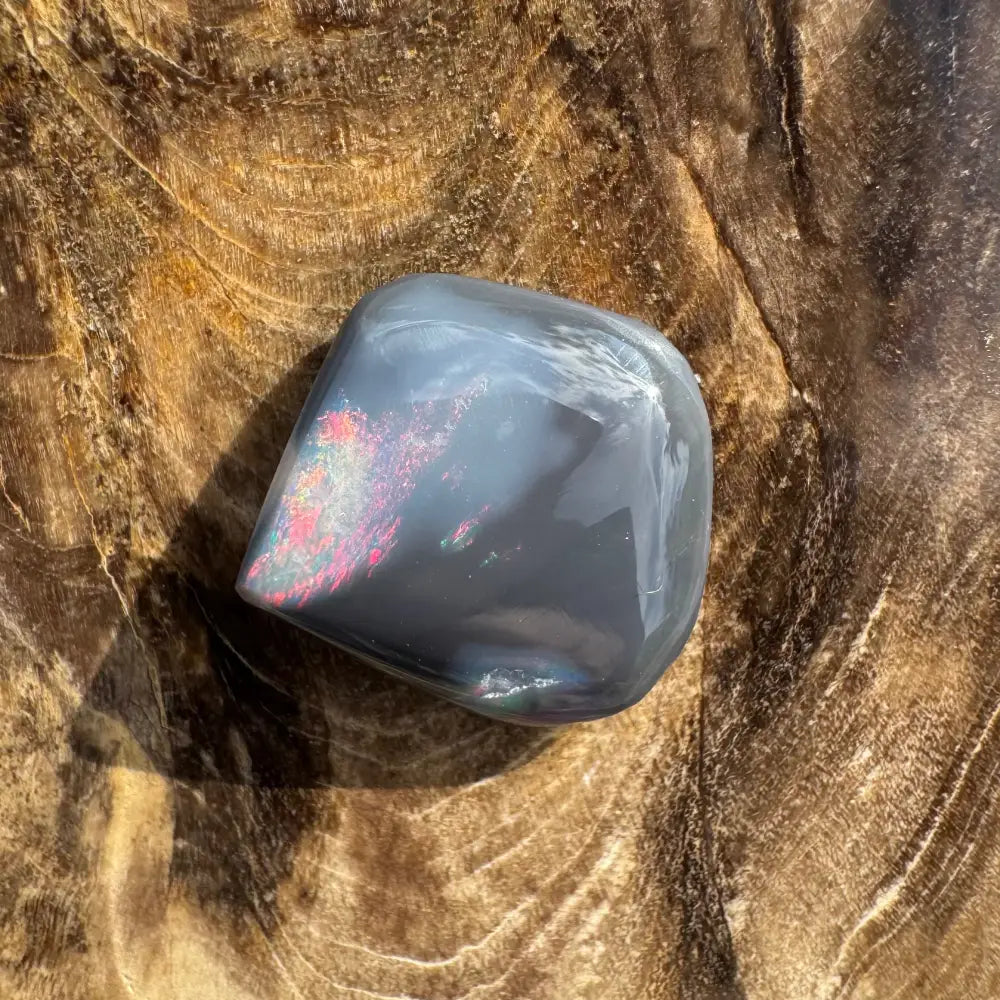 Polished gray stone with iridescent shimmer from Hand-Cut Solid Lightning Ridge Black Opal 4.0 carats
