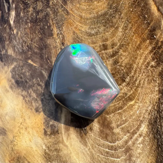 Polished Black Opal displaying vibrant color play in the Hand-Cut Solid Lightning Ridge Black Opal 4.0carat