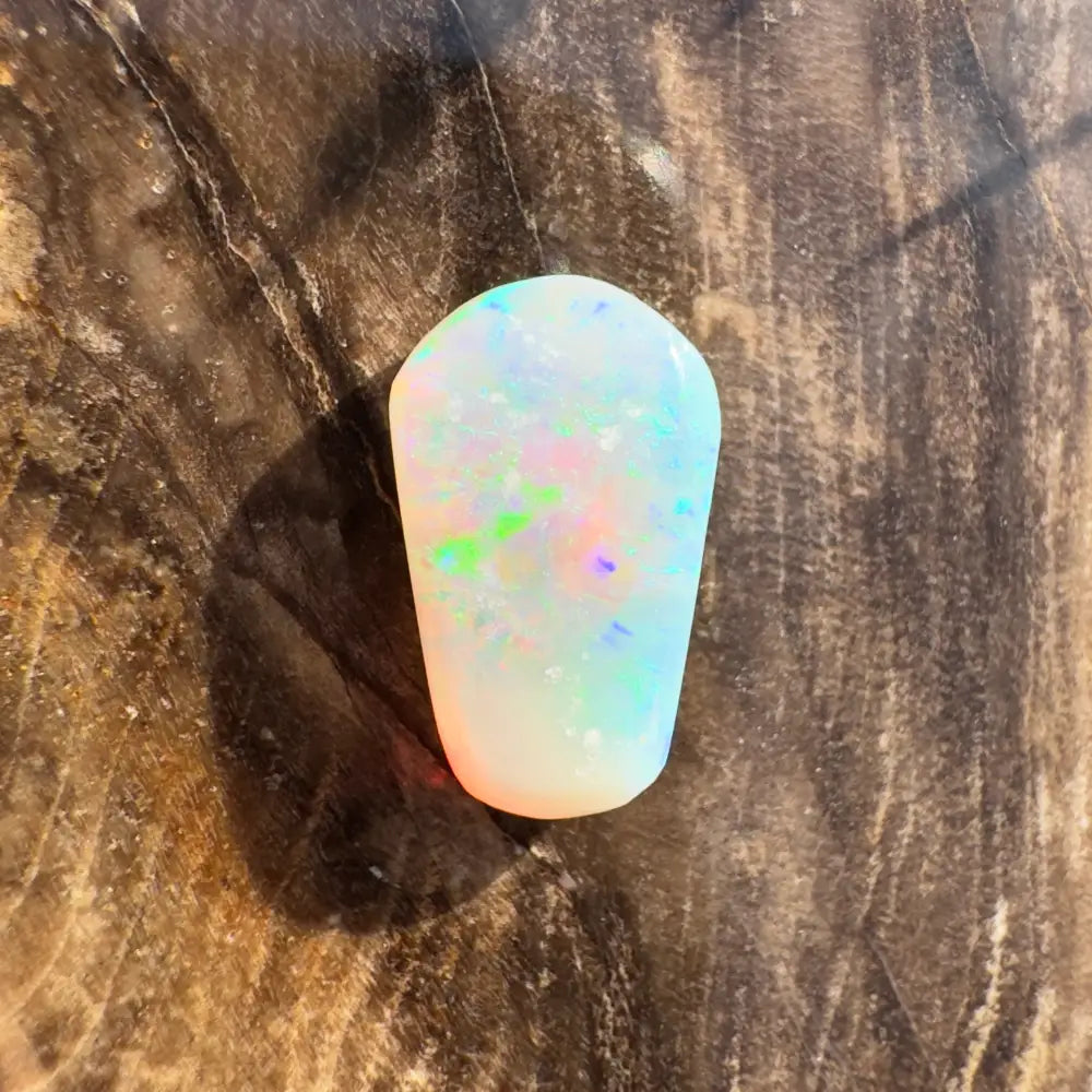 Iridescent opal gemstone displayed in a hand-cut solid Lightning Ridge Crystal Opal 1.0 carat