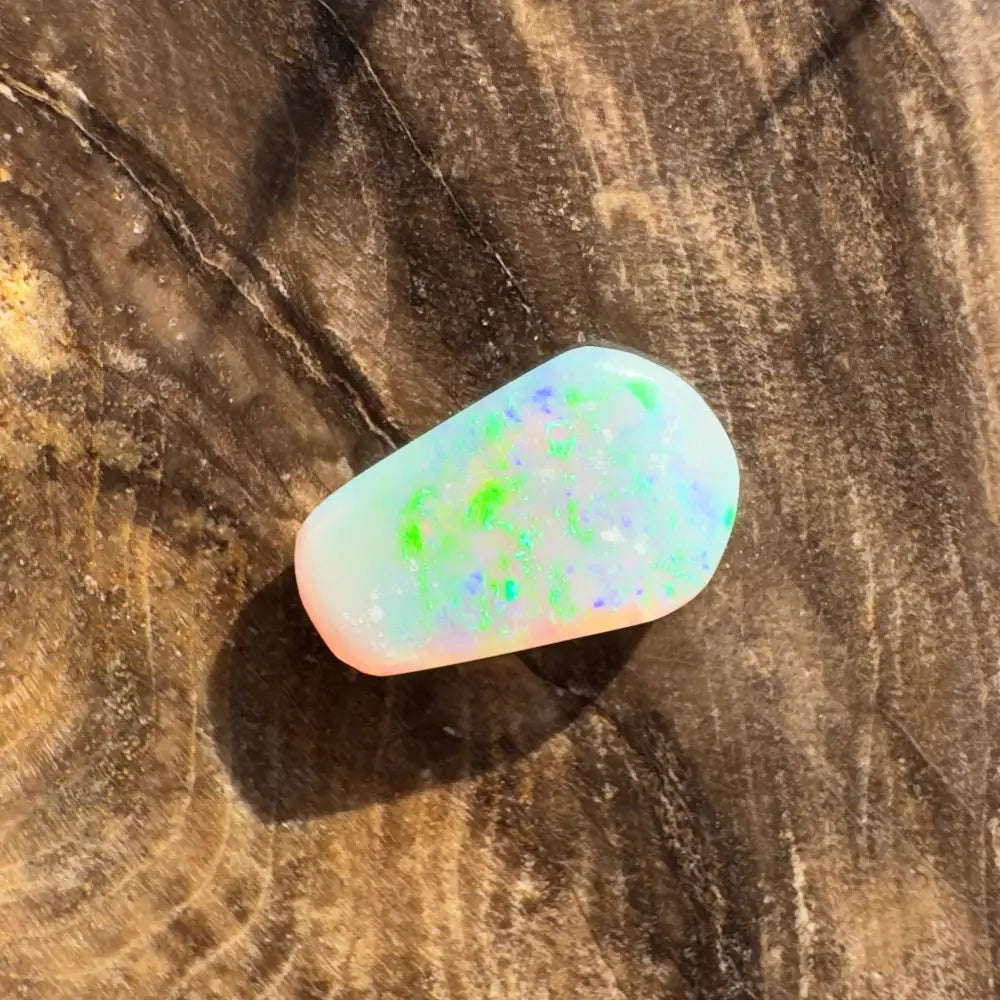 Iridescent opal cabochon displayed in Hand-Cut Solid Lightning Ridge Crystal Opal 1.0carat