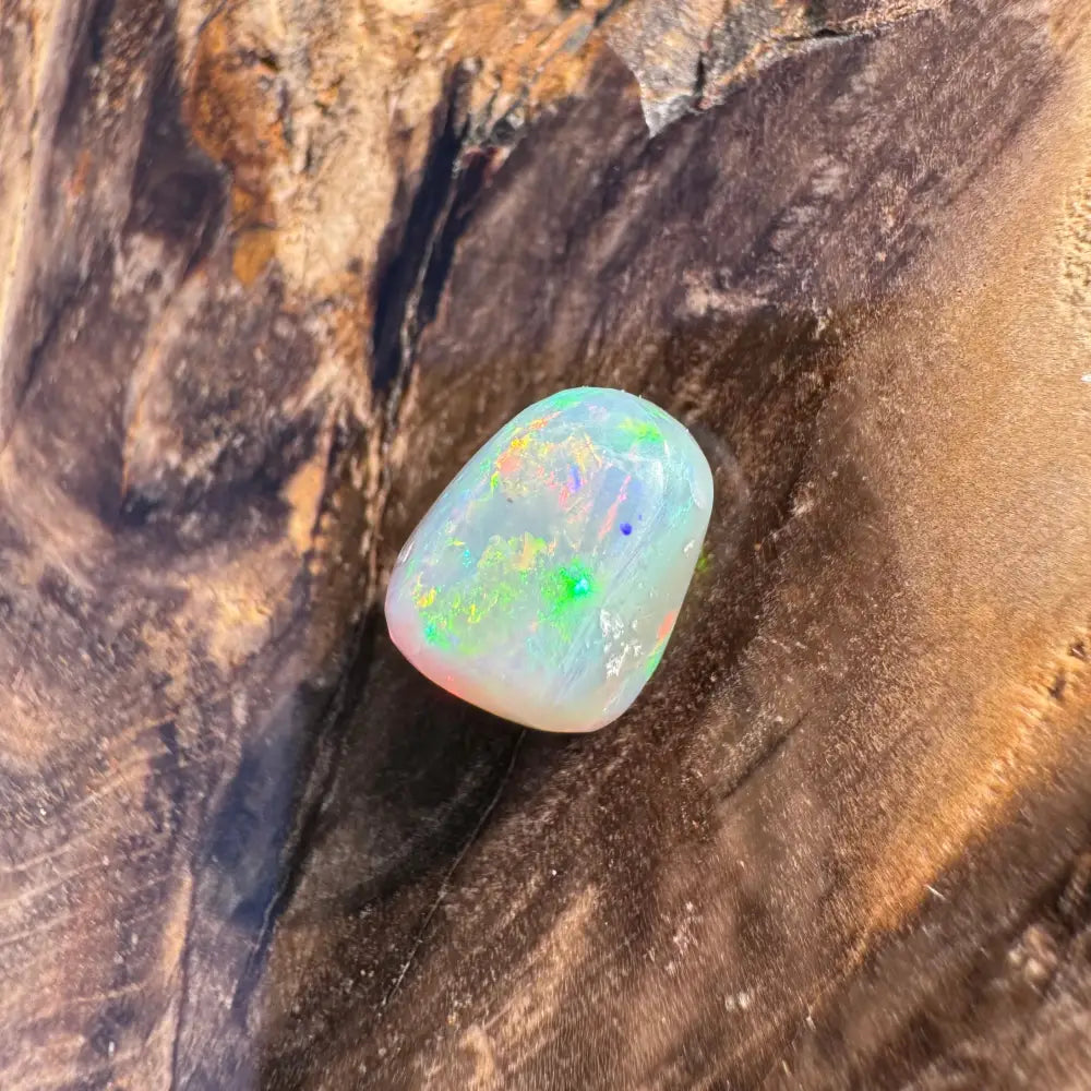 Polished Lightning Ridge Opal with iridescent colors in a 2.4-carat hand-cut setting