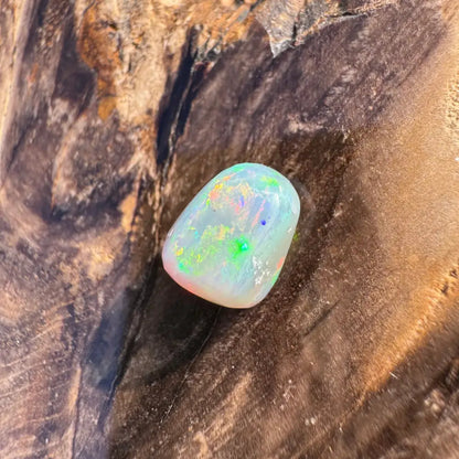 Polished Lightning Ridge Opal with iridescent colors in a 2.4-carat hand-cut setting