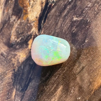 Polished Lightning Ridge Opal gemstone with iridescent play-of-color in a 2.4carat hand-cut piece
