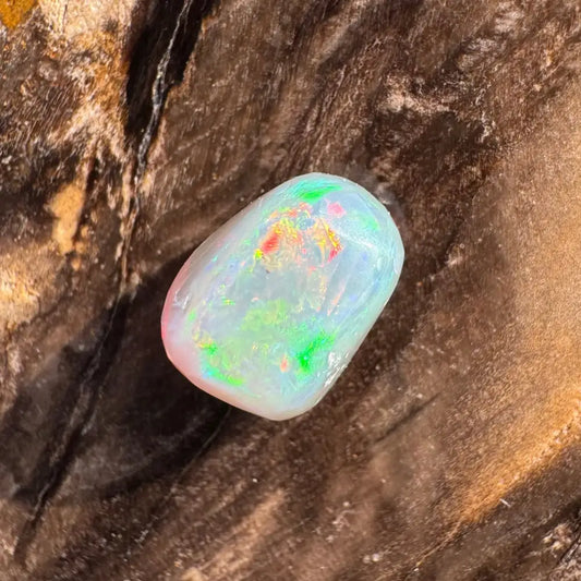 Polished Lightning Ridge Opal with green and red flashes in a hand-cut 2.4carat gemstone
