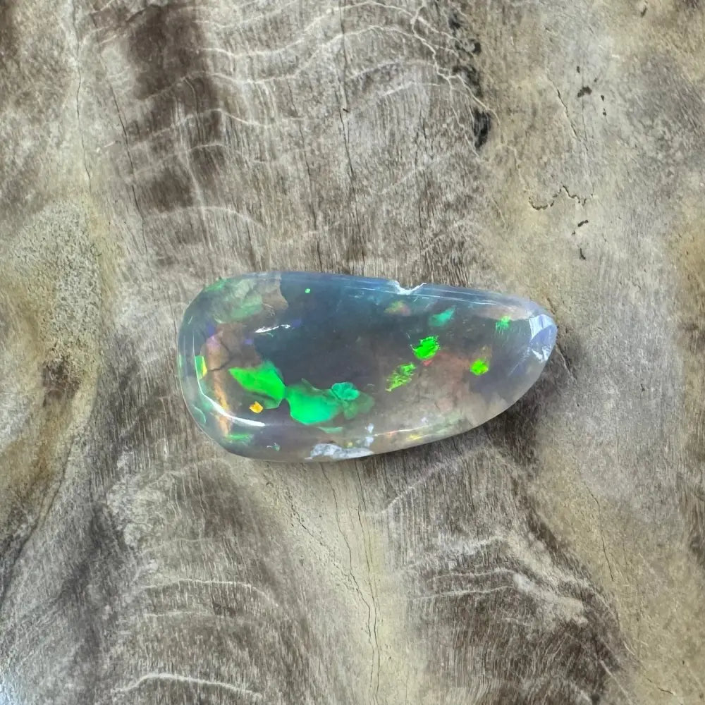 Translucent Lightning Ridge Opal with vivid green flashes, 2.6 carats, handcrafted and cut