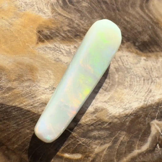 Elongated iridescent opal cabochon displayed in a Hand-Cut Solid Lightning Ridge Opal 7.5carat