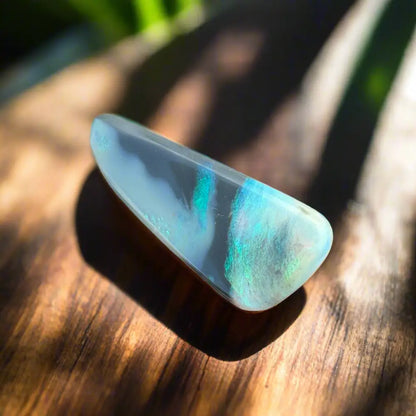 Iridescent opal gemstone from Lightning Ridge in a hand-cut 2.9-carat semi-black opal display