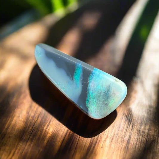 Iridescent opal gemstone from Lightning Ridge in a hand-cut 2.9-carat semi-black opal display