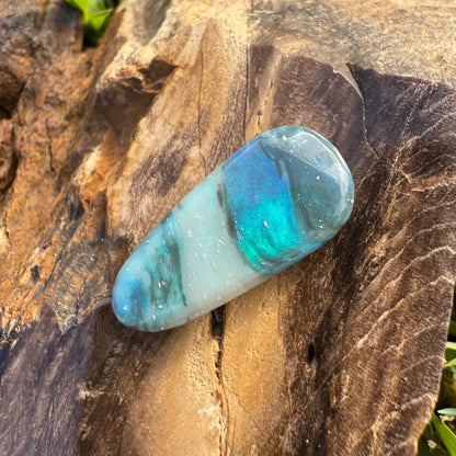 Polished iridescent blue and white semi black opal gemstone in product description