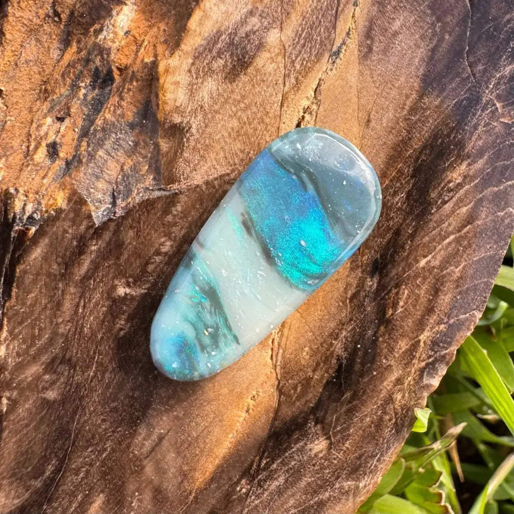 Iridescent blue and white polished stone in the Hand-Cut Solid Lightning Ridge Semi Black Opal 4.9 carat