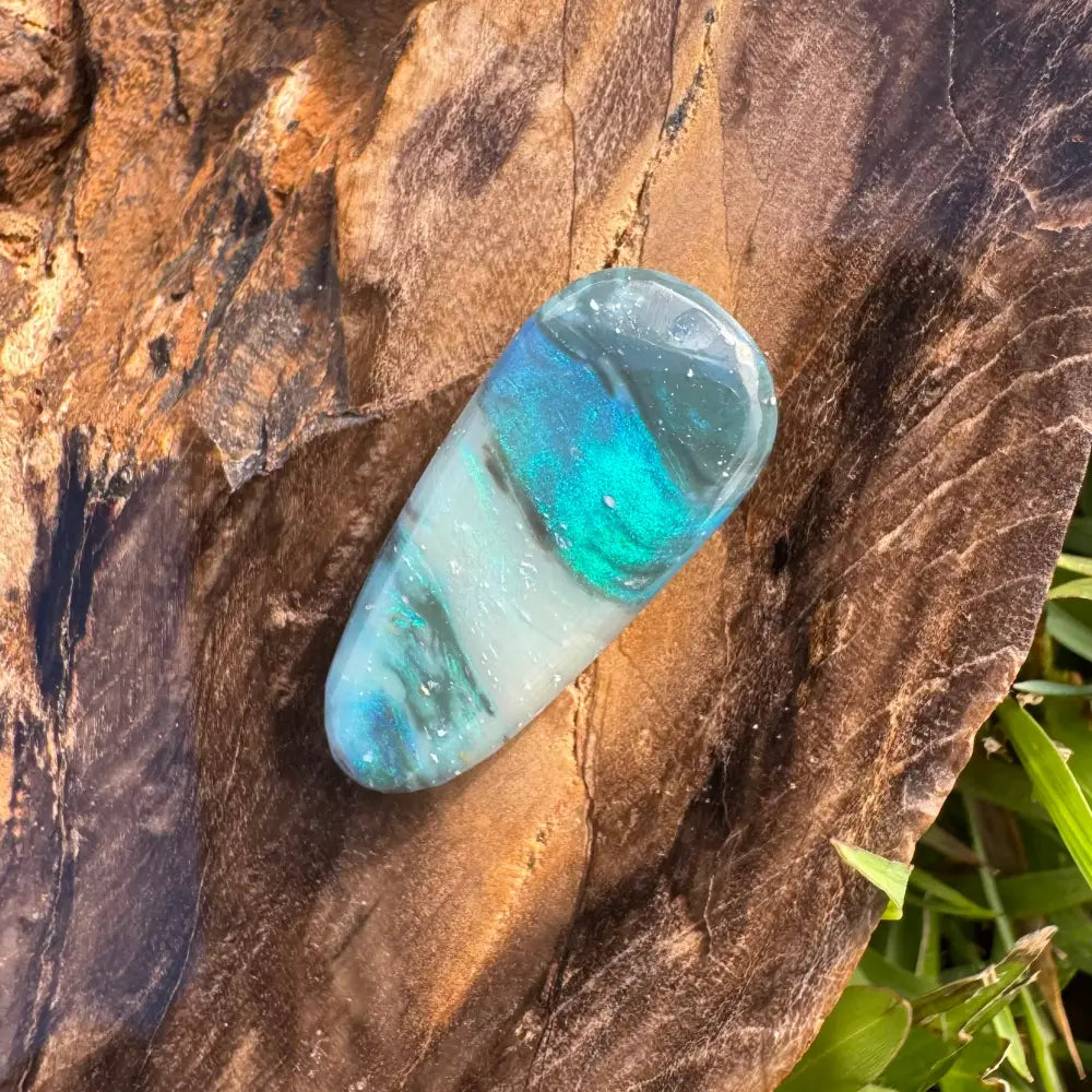 Polished iridescent blue and white Lightning Ridge semi-black Opal gemstone for jewelry