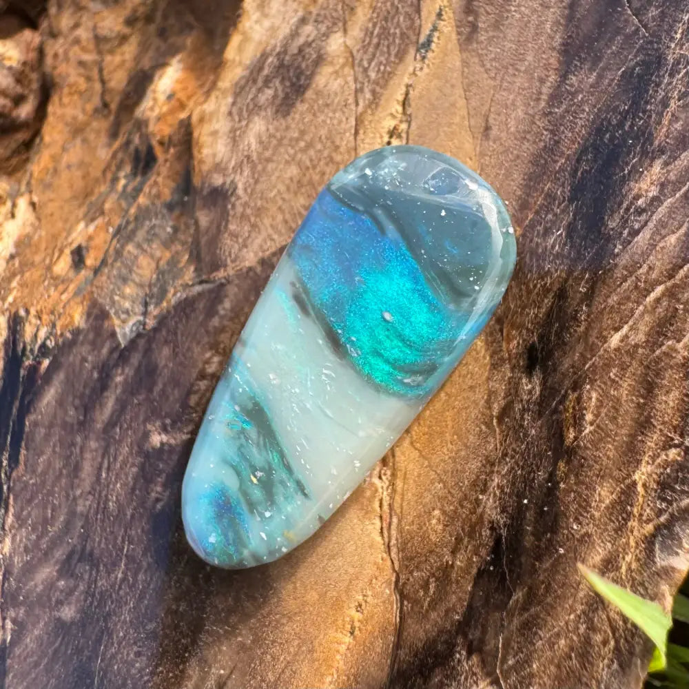 Iridescent blue and green resin pendant displayed with Hand-Cut Solid Lightning Ridge Semi Black Opal 4.9carat