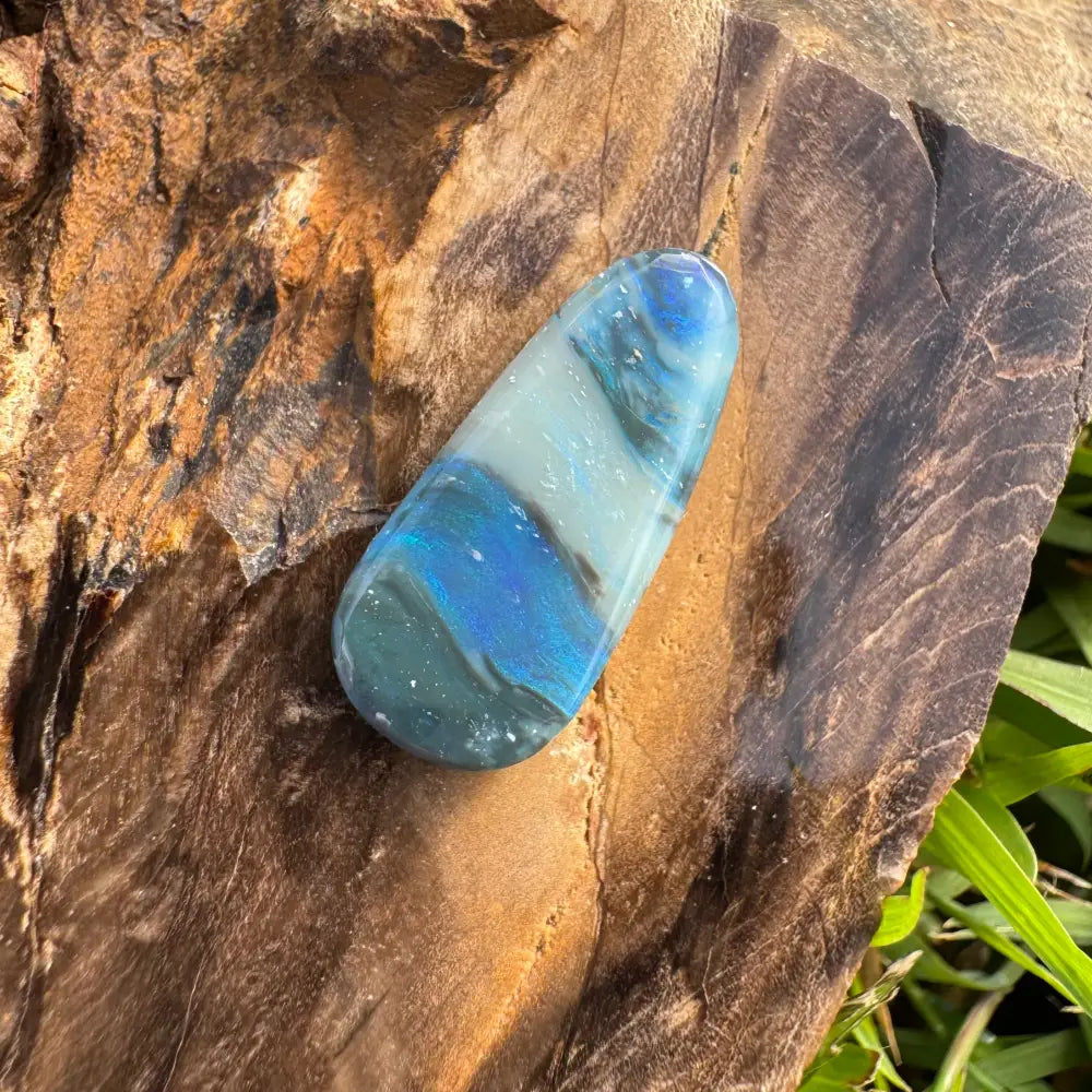 Teardrop-shaped polished blue and white stone from Hand-Cut Solid Lightning Ridge Opal 4.9carat