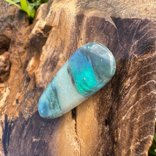 Polished teardrop-shaped Lightning Ridge semi black opal 4.9 carats with iridescent shine