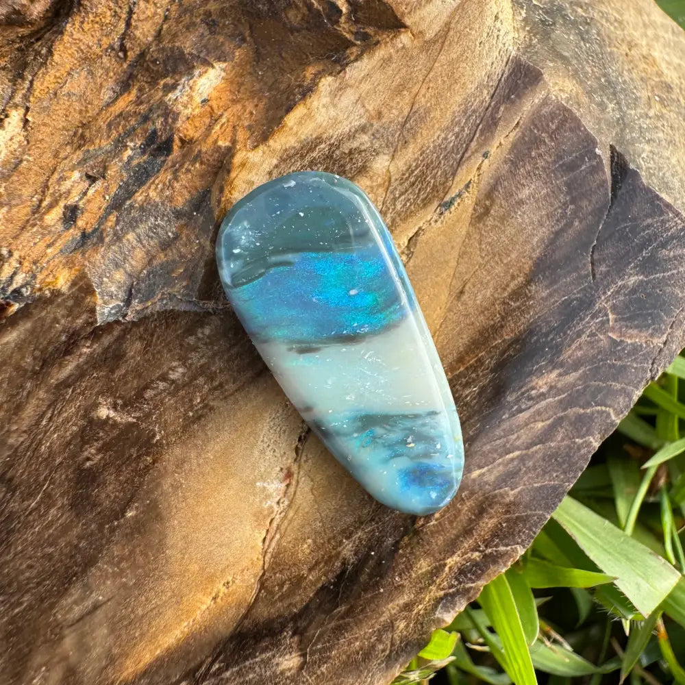 Iridescent blue and white polished Lightning Ridge semi black opal gemstone
