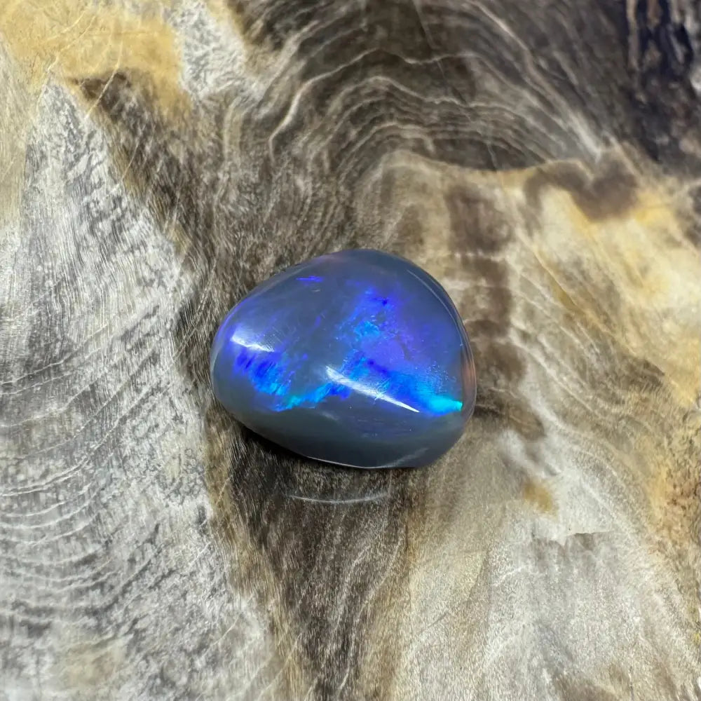 Polished blue opal with iridescent flashes from Hand-Cut Solid Lightning Ridge Semiblack Opal 5.4 carats