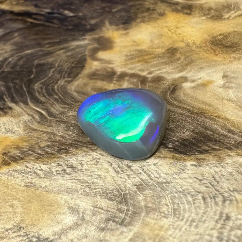 Iridescent Opal gemstone from Lightning Ridge in a 5.4-carat hand-cut semi-black gemstone