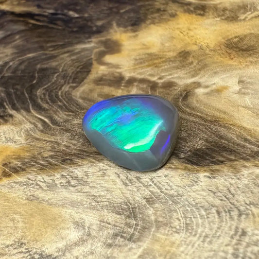 Iridescent Opal gemstone from Lightning Ridge in a 5.4-carat hand-cut semi-black gemstone