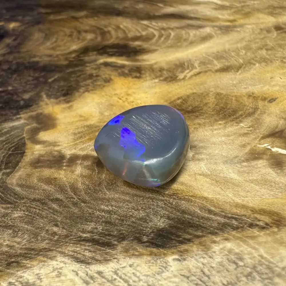 Polished Lightning Ridge semi black opal gemstone with blue and green iridescence for jewelry