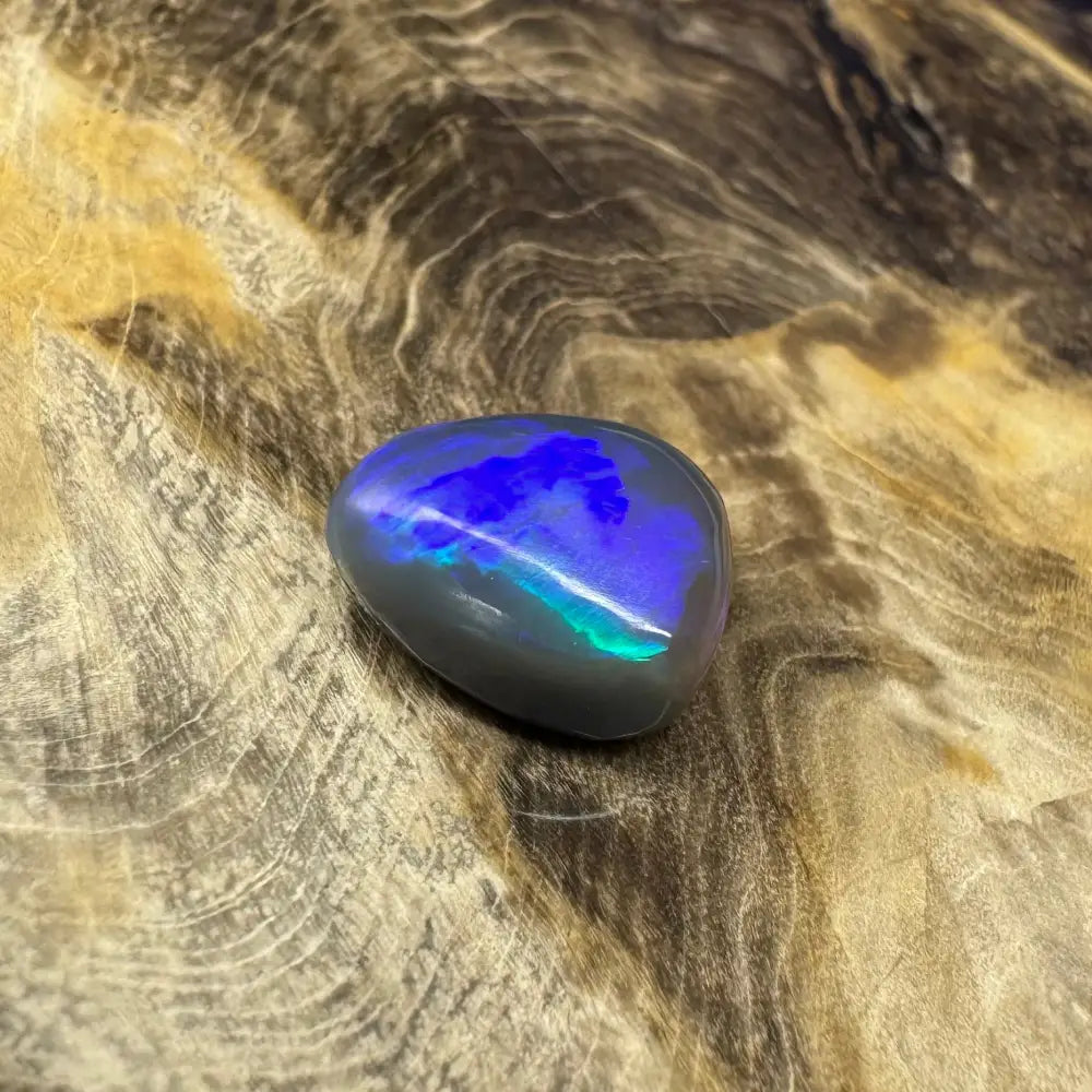 Polished Lightning Ridge semi black Opal showcasing blue and green iridescence in a 5.4 carat product