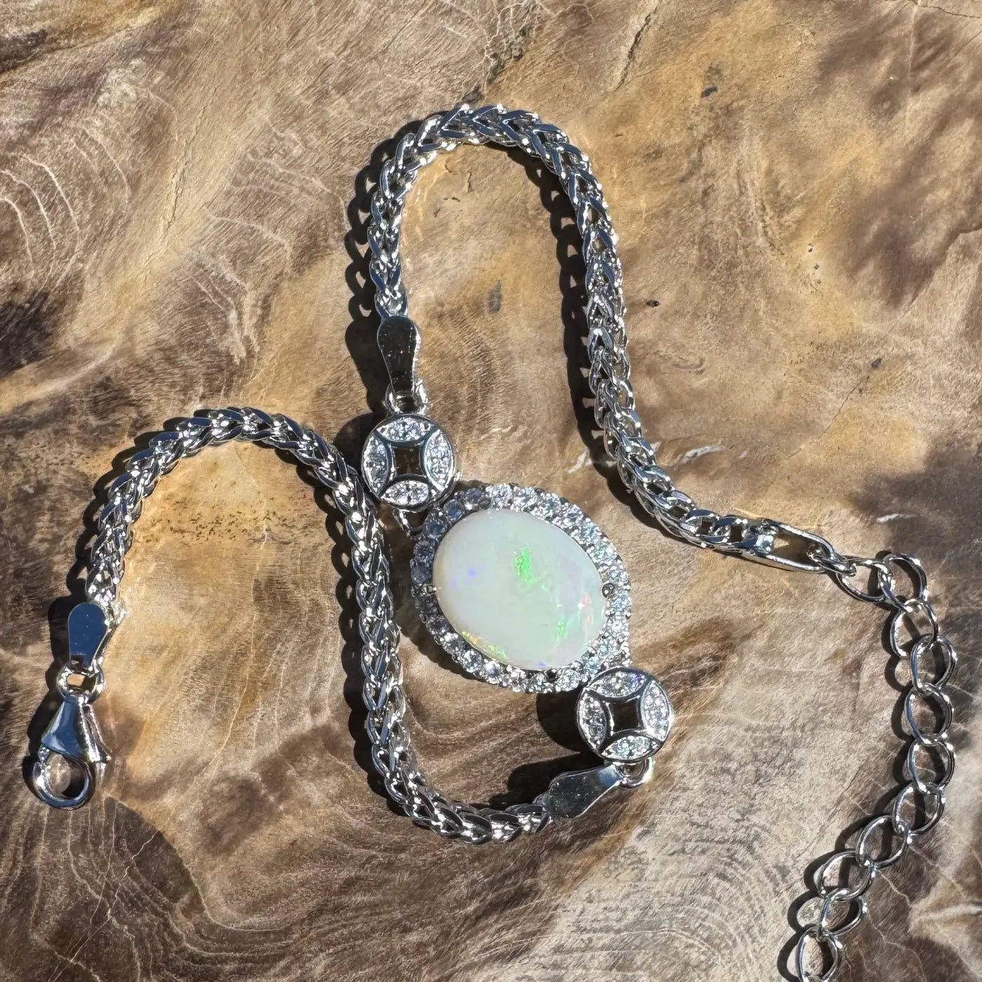 Silver opal pendant necklace displaying a handcrafted 1.1ct Coober Pedy Opal and Cubic Zirconia design