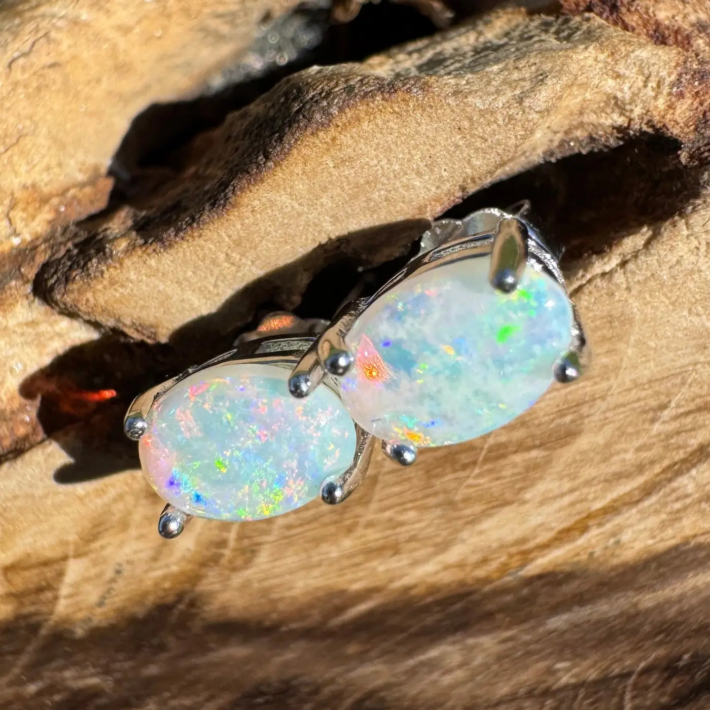 Pair of handcrafted Kimberley Blaze Lightning Ridge opal stud earrings showcasing vibrant color