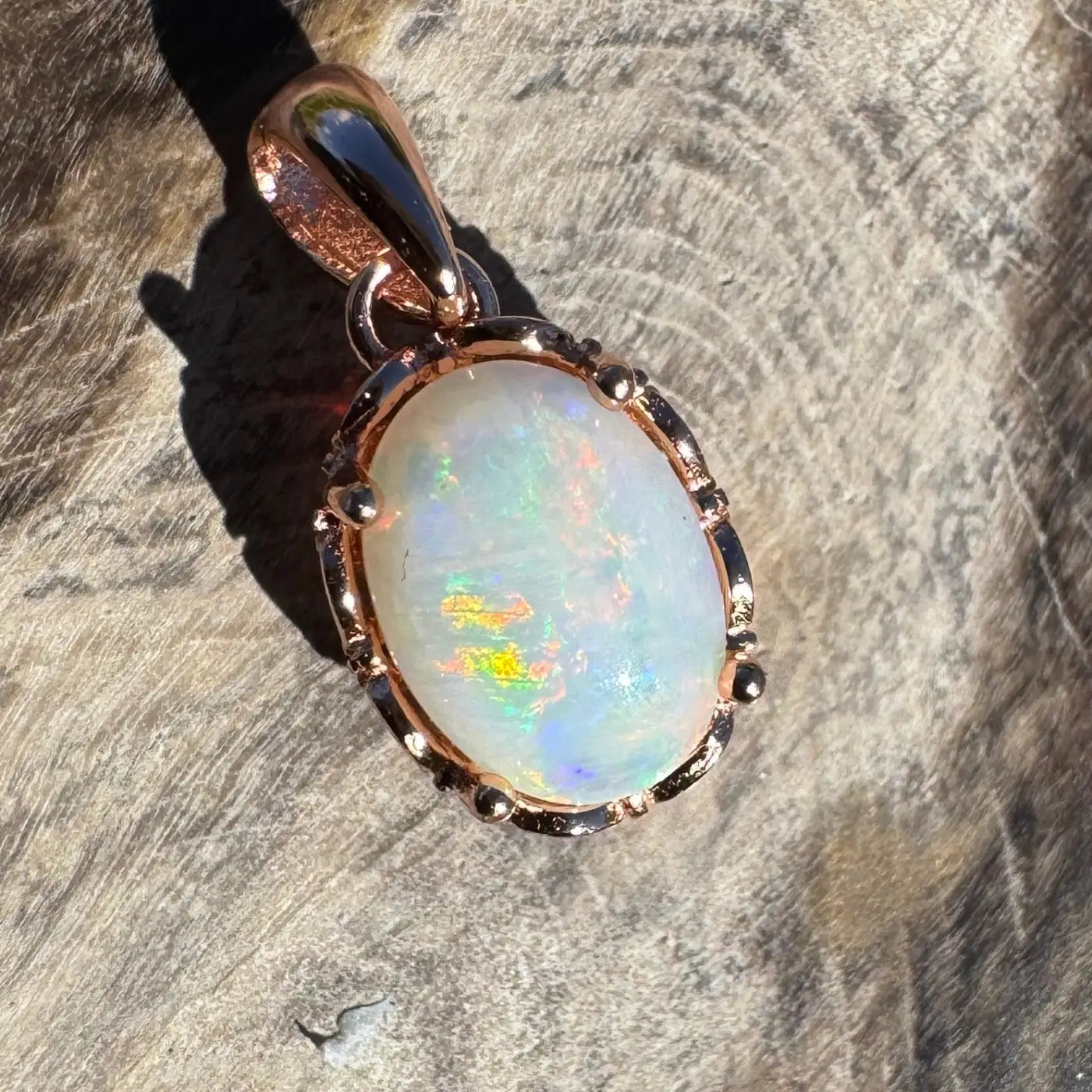 Oval opal pendant with rose gold setting from Larapinta Flame handcrafted jewelry collection