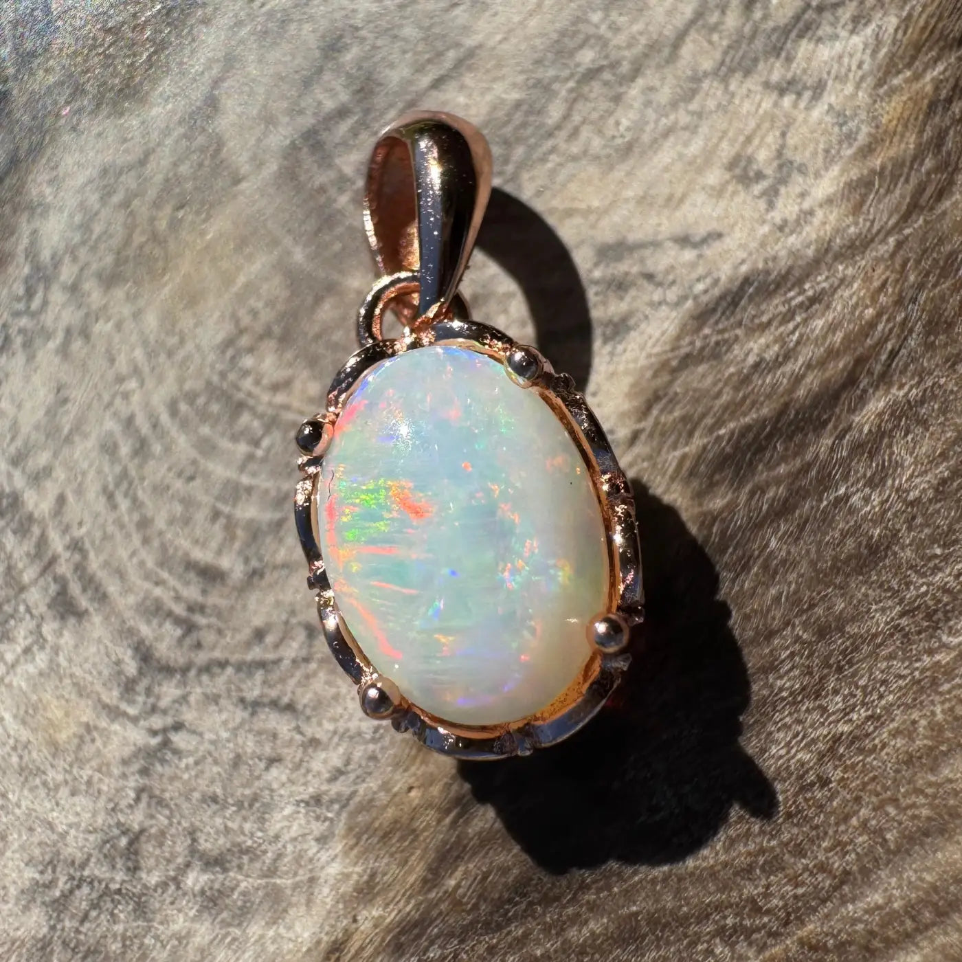 Oval opal pendant with rose gold setting from Larapinta Flame handcrafted sterling silver jewelry