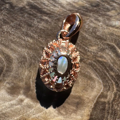 Rose gold pendant with iridescent Coober Pedy opal on sterling silver chain
